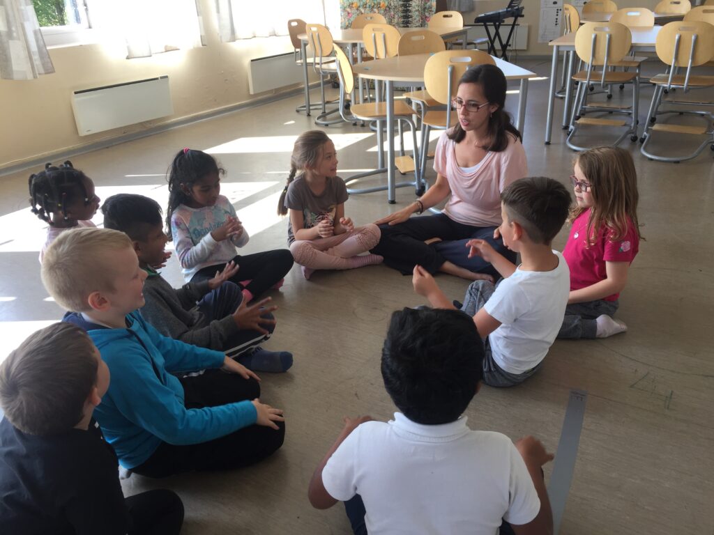 Team member of Artsy & Me, Michelle Yarnell, leading students in a Kodaly Music Practice